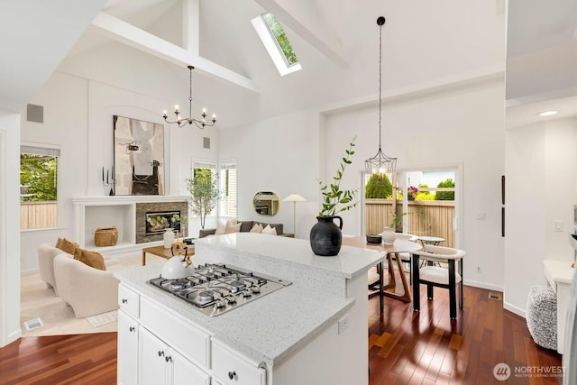 4213 249th Ct SE, Sammamish, WA 98029 - kitchen featuring stainless steel gas cooktop, a chandelier, high vaulted ceiling, dark wood finished floors, and plenty of natural light