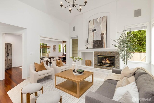 4213 249th Ct SE, Sammamish, WA 98029 - living area with a chandelier, wood finished floors, high vaulted ceiling, and a glass covered fireplace