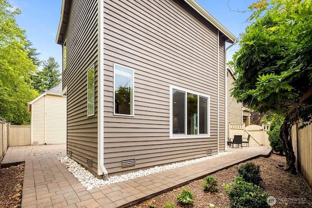 4213 249th Ct SE, Sammamish, WA 98029 - view of side of home featuring a fenced backyard, a patio area, and a gate