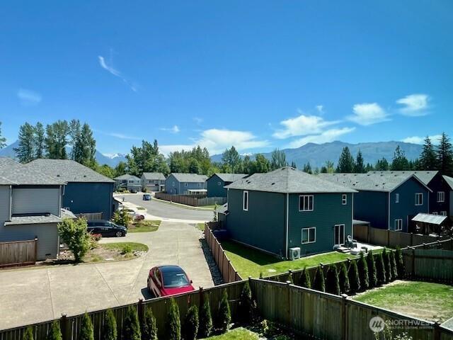 1342 Cascade St, Sultan, WA 98294 - view of side of property featuring a residential view, a fenced backyard, and a mountain view