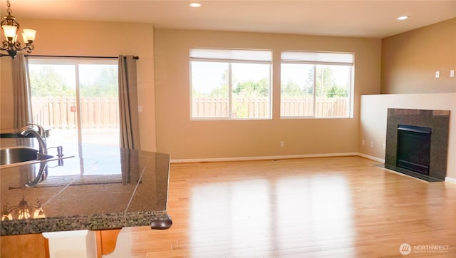 21502 51st Ave S Unit 44, Kent, WA 98032 - unfurnished living room featuring light wood-style floors, a tiled fireplace, a chandelier, and recessed lighting