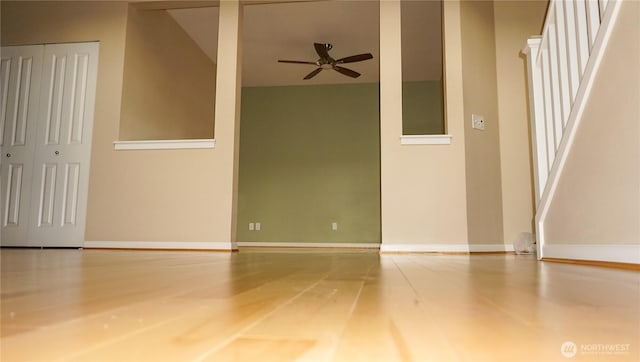 21502 51st Ave S Unit 44, Kent, WA 98032 - empty room with a ceiling fan, stairway, and wood finished floors