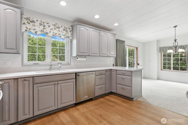 23704 9th Pl W, Bothell, WA 98021 - kitchen featuring stainless steel dishwasher, gray cabinets, a peninsula, light countertops, and decorative light fixtures