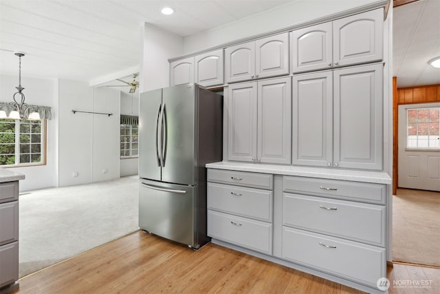23704 9th Pl W, Bothell, WA 98021 - kitchen with freestanding refrigerator, gray cabinets, plenty of natural light, a chandelier, and recessed lighting