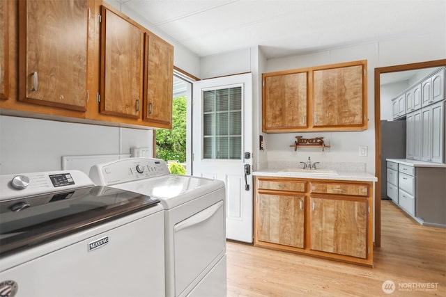 23704 9th Pl W, Bothell, WA 98021 - laundry area featuring independent washer and dryer, cabinet space, and light wood-style flooring