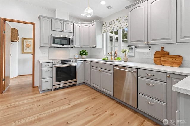 23704 9th Pl W, Bothell, WA 98021 - kitchen featuring appliances with stainless steel finishes, gray cabinets, and light wood-style floors