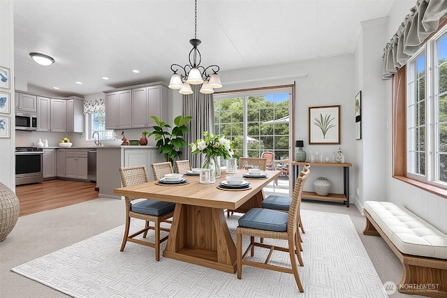 23704 9th Pl W, Bothell, WA 98021 - dining space with light colored carpet, a chandelier, and recessed lighting