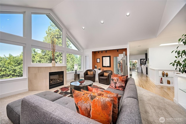 63 Red Cedar Ln, Port Ludlow, WA 98365 - living room with plenty of natural light, a tile fireplace, high vaulted ceiling, recessed lighting, and wood finished floors