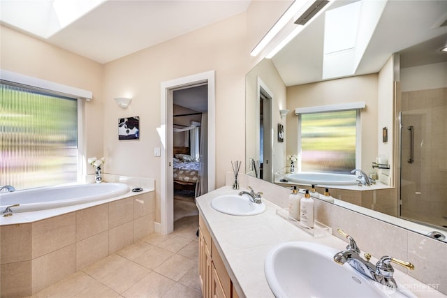 63 Red Cedar Ln, Port Ludlow, WA 98365 - ensuite bathroom with a skylight, tile patterned floors, a garden tub, double vanity, and a stall shower