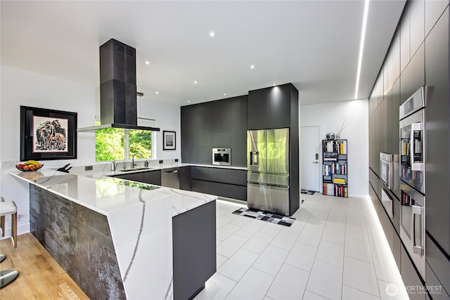 63 Red Cedar Ln, Port Ludlow, WA 98365 - kitchen featuring stainless steel fridge, modern cabinets, a peninsula, light stone countertops, and ventilation hood