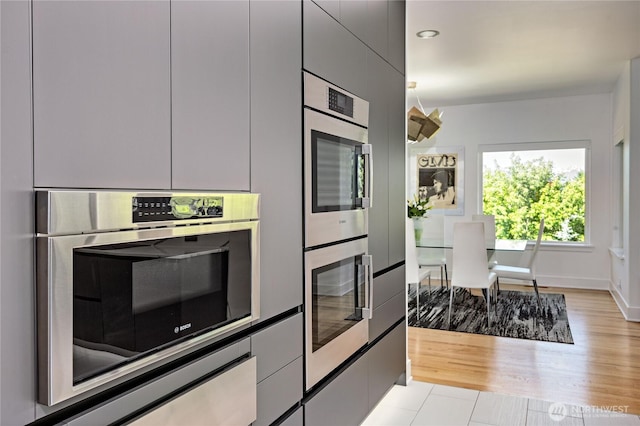 63 Red Cedar Ln, Port Ludlow, WA 98365 - kitchen featuring double oven, recessed lighting, modern cabinets, and light wood-style flooring