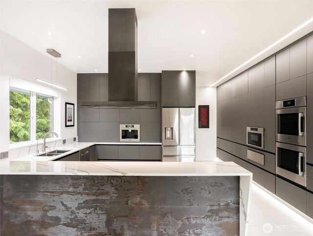 63 Red Cedar Ln, Port Ludlow, WA 98365 - kitchen featuring appliances with stainless steel finishes, island exhaust hood, modern cabinets, gray cabinets, and light stone countertops