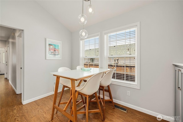 244 N Emerson Ave, Wenatchee, WA 98801 - dining space with vaulted ceiling and wood finished floors