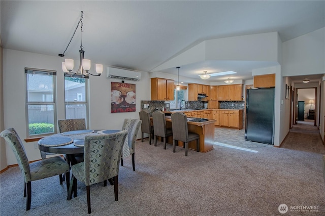 180N Mount Christie Dr, Hoodsport, WA 98548 - dining room with vaulted ceiling, light colored carpet, a chandelier, and a wall unit AC