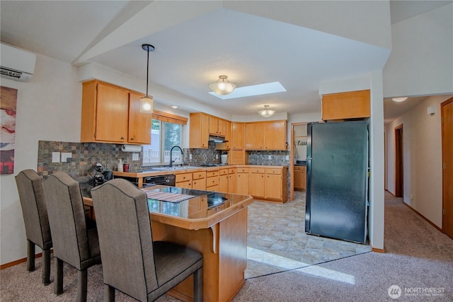 180N Mount Christie Dr, Hoodsport, WA 98548 - kitchen featuring black appliances, a peninsula, a wall unit AC, decorative backsplash, and under cabinet range hood