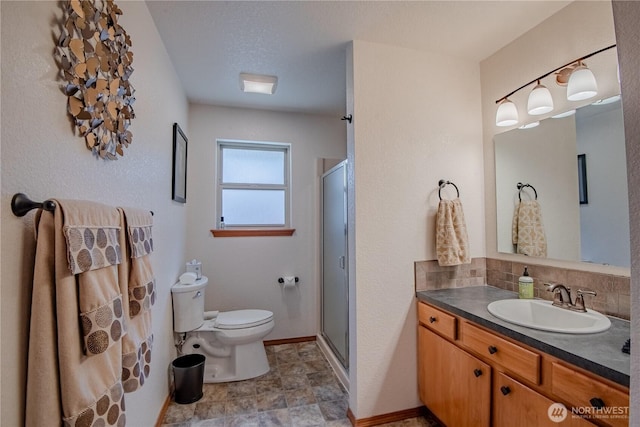 180N Mount Christie Dr, Hoodsport, WA 98548 - full bathroom with vanity, toilet, a shower stall, and decorative backsplash