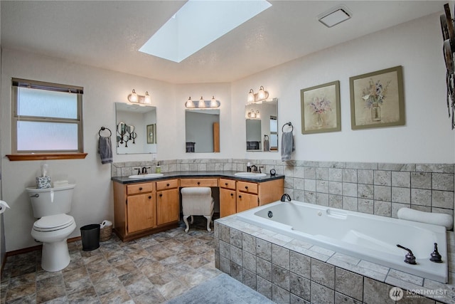 180N Mount Christie Dr, Hoodsport, WA 98548 - full bath with a skylight, a garden tub, double vanity, and toilet