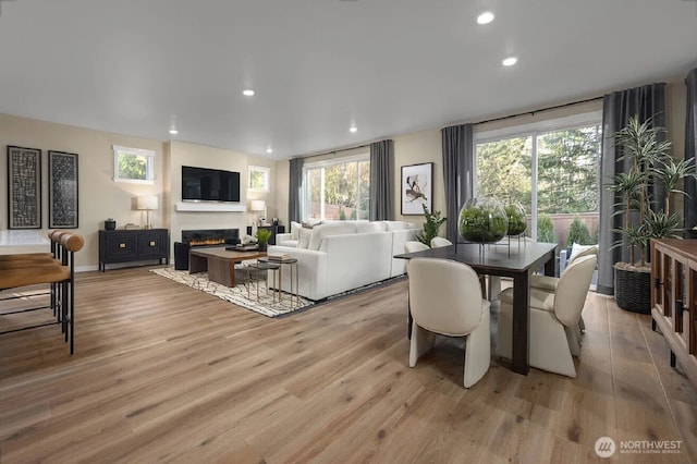 505 184th Street Ct E Unit 53, Spanaway, WA 98387 - dining room featuring a glass covered fireplace, light wood-style floors, and recessed lighting