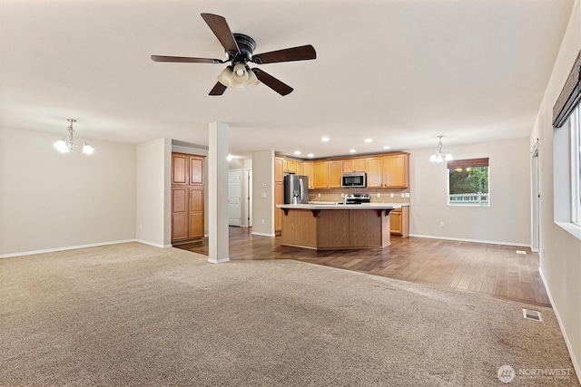 3632 London Loop NE, Lacey, WA 98516 - unfurnished living room with a chandelier, light carpet, recessed lighting, and a ceiling fan
