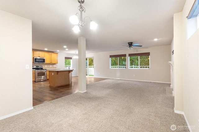 3632 London Loop NE, Lacey, WA 98516 - unfurnished living room featuring light colored carpet, recessed lighting, plenty of natural light, ceiling fan, and a chandelier
