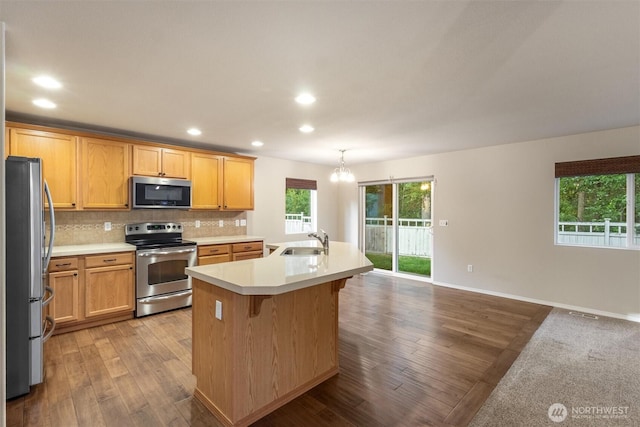 3632 London Loop NE, Lacey, WA 98516 - kitchen with stainless steel appliances, light countertops, wood finished floors, tasteful backsplash, and recessed lighting