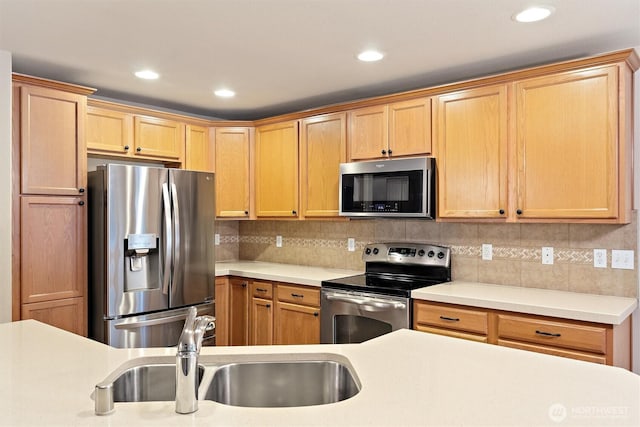 3632 London Loop NE, Lacey, WA 98516 - kitchen with stainless steel appliances, light countertops, decorative backsplash, recessed lighting, and light brown cabinets