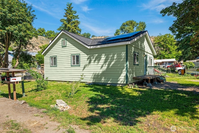 101 N Elm St N, Omak, WA 98841 - view of side of property with roof mounted solar panels and a lawn