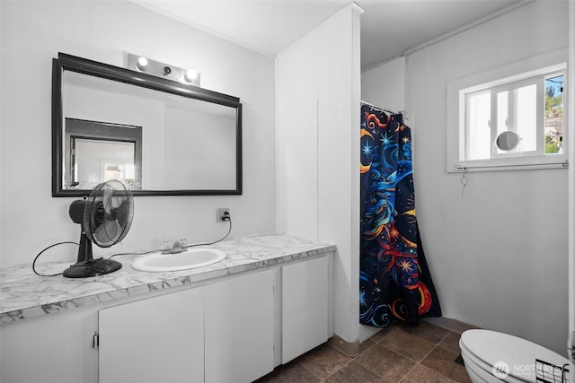 101 N Elm St N, Omak, WA 98841 - bathroom featuring vanity, toilet, stone finish flooring, and a shower with shower curtain