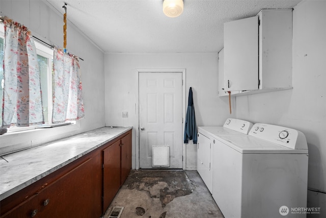 101 N Elm St N, Omak, WA 98841 - laundry area featuring independent washer and dryer, cabinet space, and a textured ceiling