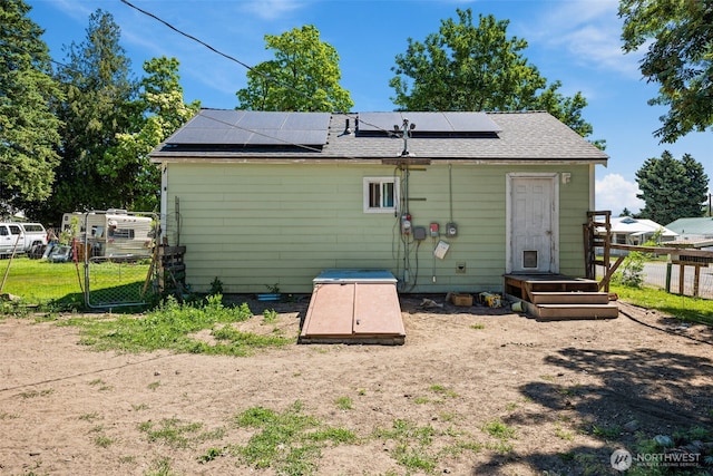 101 N Elm St N, Omak, WA 98841 - rear view of property with roof mounted solar panels and roof with shingles