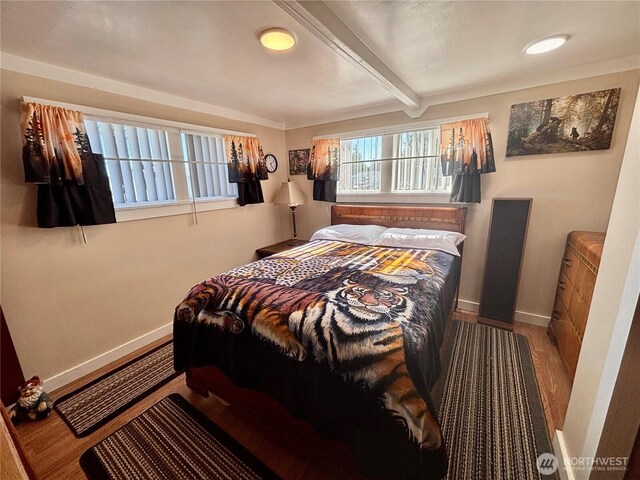 545 Hendricks St Unit 33, Port Townsend, WA 98368 - bedroom featuring beamed ceiling and wood finished floors