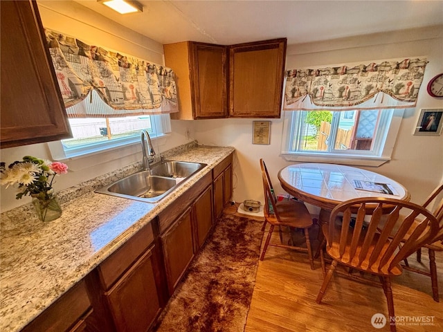 545 Hendricks St Unit 33, Port Townsend, WA 98368 - kitchen featuring wood finished floors, light countertops, and brown cabinetry