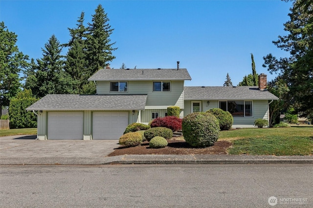 1001 Garden Dr, Lynden, WA 98264 - traditional-style house with a chimney, asphalt driveway, a front yard, a garage, and a shingled roof