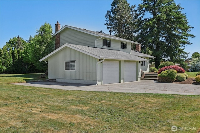 1001 Garden Dr, Lynden, WA 98264 - rear view of house with concrete driveway, a chimney, a yard, a garage, and roof with shingles