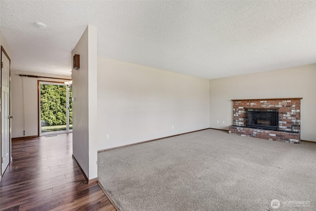 1001 Garden Dr, Lynden, WA 98264 - unfurnished living room with a textured ceiling, wood finished floors, and a fireplace