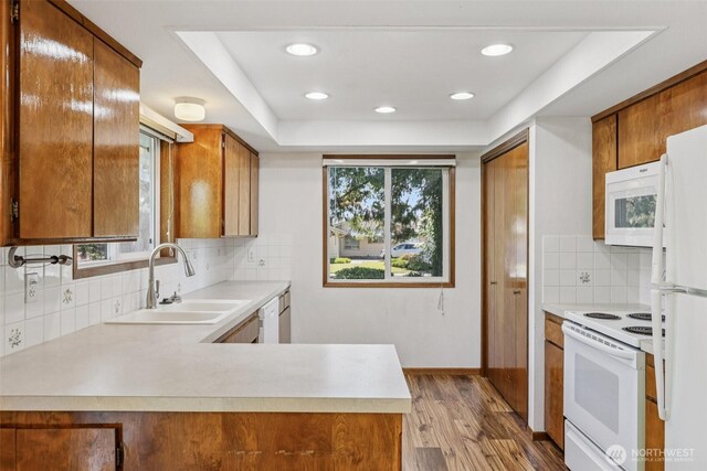 1001 Garden Dr, Lynden, WA 98264 - kitchen with white appliances, light countertops, brown cabinets, wood finished floors, and recessed lighting