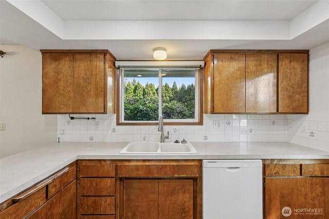 1001 Garden Dr, Lynden, WA 98264 - kitchen featuring white dishwasher, light countertops, brown cabinets, and decorative backsplash