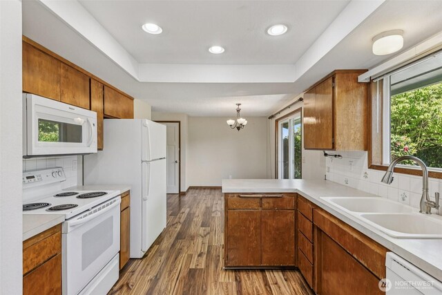 1001 Garden Dr, Lynden, WA 98264 - kitchen featuring white appliances, light countertops, decorative backsplash, brown cabinetry, and recessed lighting