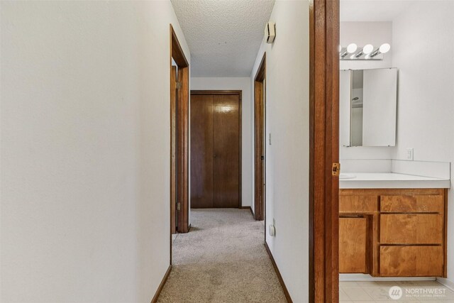 1001 Garden Dr, Lynden, WA 98264 - hallway with light colored carpet and a textured ceiling