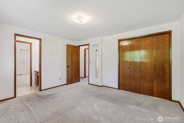 1001 Garden Dr, Lynden, WA 98264 - unfurnished bedroom with light colored carpet, a closet, a textured ceiling, and ensuite bathroom