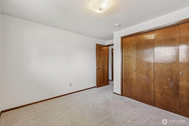 1001 Garden Dr, Lynden, WA 98264 - unfurnished bedroom featuring carpet flooring, a closet, and a textured ceiling