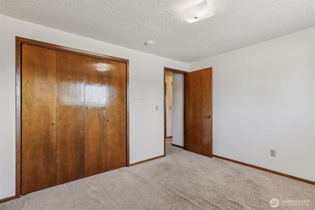 1001 Garden Dr, Lynden, WA 98264 - unfurnished bedroom featuring a closet, carpet, and a textured ceiling