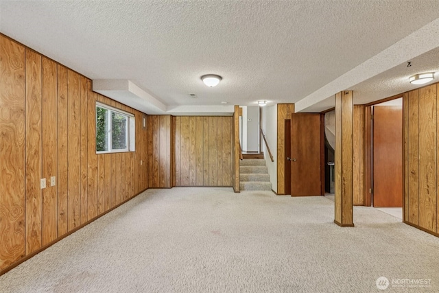 1001 Garden Dr, Lynden, WA 98264 - below grade area featuring wood walls, a textured ceiling, light colored carpet, and stairway