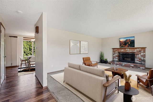 1001 Garden Dr, Lynden, WA 98264 - living area featuring a textured ceiling, wood finished floors, and a brick fireplace