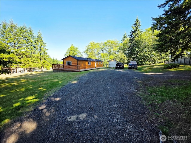 255 S Union Rd, Elma, WA 98541 - view of side of property with a deck, a lawn, a detached garage, and driveway
