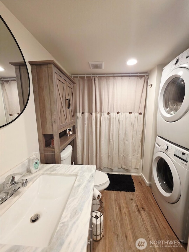 255 S Union Rd, Elma, WA 98541 - laundry area featuring stacked washer and clothes dryer and light wood finished floors