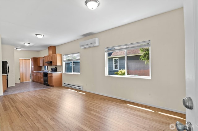 2415 Cedar St, Everett, WA 98201 - kitchen with black range with electric cooktop, a wall mounted air conditioner, a baseboard heating unit, and light countertops