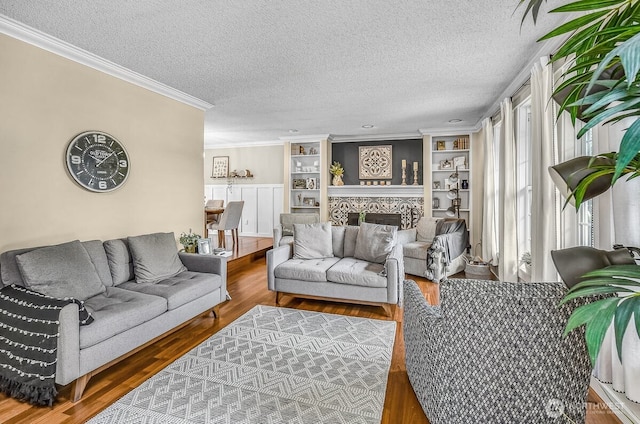 12907 SE 245th St, Kent, WA 98030 - living area featuring wood finished floors, crown molding, built in features, and a textured ceiling