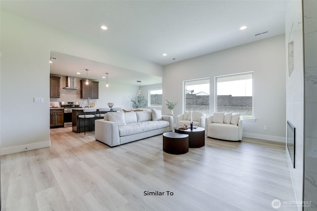 4246 W Sandy Ct, Moses Lake, WA 98837 - living area featuring light wood-style flooring, recessed lighting, and a large fireplace