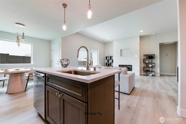 4246 W Sandy Ct, Moses Lake, WA 98837 - kitchen with light wood finished floors, dark brown cabinetry, hanging light fixtures, a kitchen bar, and recessed lighting
